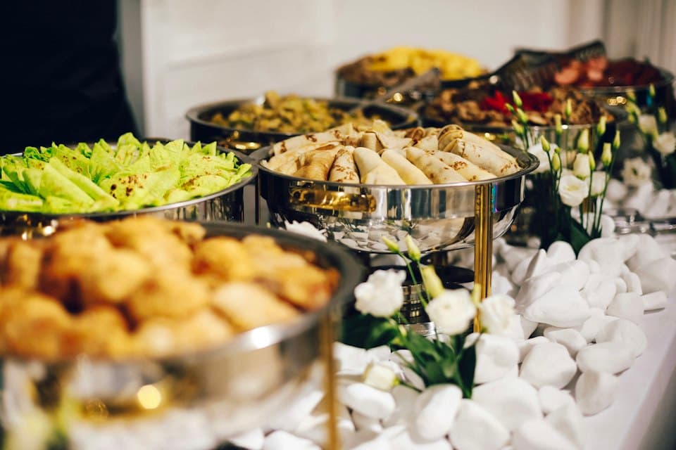 A buffet spread with serving dishes and fresh food